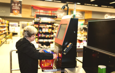 Woman paying in a supermarket in a self service