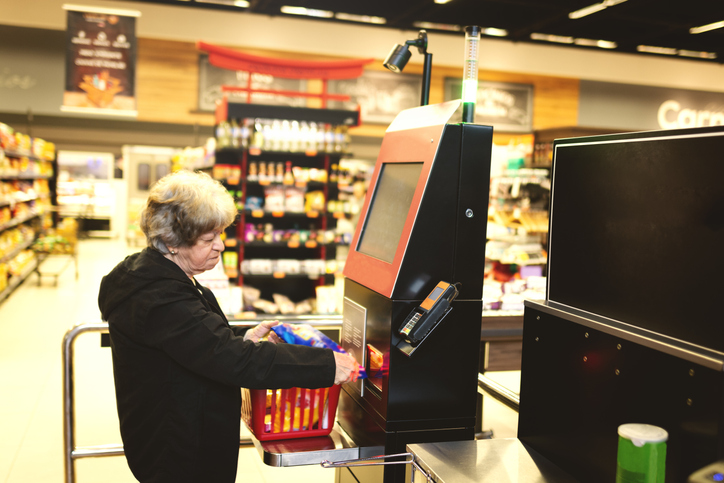 Woman paying in a supermarket in a self service